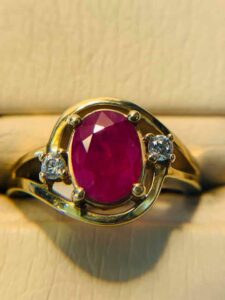 a stunning ring with a red stone set in the middle