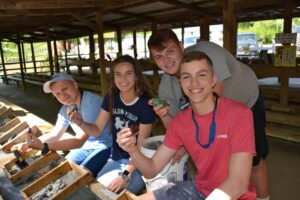 four siblings show off their haul from sifting for gemstones at Gem Mountain