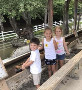 three kids smile while flume mining at Gem Mountain