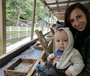 A mom and her toddler sift for gemstones at Gem Mountain