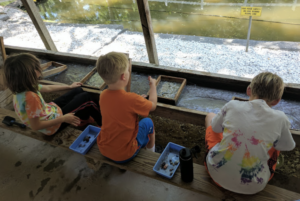 Three young kids flume mining at Gem Mountain.