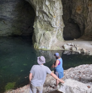 two visitors exploring the natural caverns and underground water sources at Gem Mountain